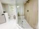 Modern bathroom with glass shower, wood-look tiles, and bright lighting at 7507 Limerick Dr, Charlotte, NC 28270