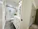 Bright bathroom featuring a glass enclosed shower, white vanity, and slate flooring at 7507 Limerick Dr, Charlotte, NC 28270