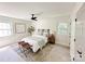 Cozy bedroom with natural light, featuring a queen bed, ceiling fan, and neutral decor at 7507 Limerick Dr, Charlotte, NC 28270