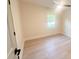 Bright bedroom features hardwood floors, ceiling fan, and natural light from the window at 7507 Limerick Dr, Charlotte, NC 28270