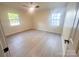 Spacious bedroom with hardwood floors and large windows providing plenty of natural light at 7507 Limerick Dr, Charlotte, NC 28270