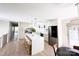 Bright, open kitchen with a waterfall island, modern pendant lighting, stainless steel appliances, and light wood floors at 7507 Limerick Dr, Charlotte, NC 28270
