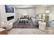 Bright living room with sleek fireplace, neutral furniture, large area rug, and staircase at 7507 Limerick Dr, Charlotte, NC 28270