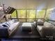 Relaxing screened porch with comfortable wicker furniture and scenic outdoor views at 7507 Limerick Dr, Charlotte, NC 28270