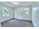 Well-lit bedroom featuring plush carpeting, dual windows, and fresh paint at 805 32Nd Street Ne Dr, Conover, NC 28613