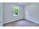 Bedroom featuring neutral carpeting and a bright window offering a peaceful view at 805 32Nd Street Ne Dr, Conover, NC 28613