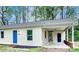 Charming single-story home with a bright blue front door and covered carport, nestled among lush trees at 805 32Nd Street Ne Dr, Conover, NC 28613