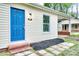 Charming home featuring a vibrant blue front door, brick steps, and stone pathway at 805 32Nd Street Ne Dr, Conover, NC 28613
