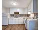 White kitchen featuring modern backsplash, sleek appliances, and bright lighting at 805 32Nd Street Ne Dr, Conover, NC 28613