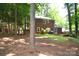 View of a backyard and the back of a two-story brick house with a well-manicured lawn at 8807 Tree Haven Dr, Charlotte, NC 28270