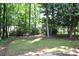 A spacious backyard enveloped by lush trees, offering a serene and private outdoor living space at 8807 Tree Haven Dr, Charlotte, NC 28270