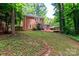 Brick home with spacious lawn, lovely landscaping, and a wood deck at 8807 Tree Haven Dr, Charlotte, NC 28270