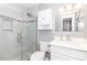 Updated bathroom with a glass-enclosed shower, white vanity, and modern lighting at 8807 Tree Haven Dr, Charlotte, NC 28270