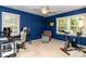 Bedroom with cool blue walls, a ceiling fan and an exercise bike by a sunny window at 8807 Tree Haven Dr, Charlotte, NC 28270