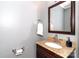 Stylish half bathroom with granite countertop, wood vanity, and modern fixtures at 8807 Tree Haven Dr, Charlotte, NC 28270