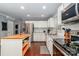 Bright kitchen with stainless steel appliances, granite countertops, and white cabinets at 8807 Tree Haven Dr, Charlotte, NC 28270