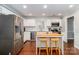 Bright kitchen with stainless steel appliances, subway tile backsplash, and butcher block island with barstool seating at 8807 Tree Haven Dr, Charlotte, NC 28270