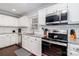 Well-equipped kitchen with granite countertops, white cabinets, and modern appliances at 8807 Tree Haven Dr, Charlotte, NC 28270