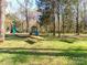 Inviting neighborhood playground with picnic tables, swings, and slides on a grassy area for Gathering fun at 8807 Tree Haven Dr, Charlotte, NC 28270