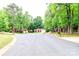 A quiet, tree-lined street showcasing well-maintained homes with green lawns, offering a peaceful neighborhood at 8807 Tree Haven Dr, Charlotte, NC 28270