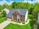 A high angle view of a brick home with beautiful landscaping and a spacious yard at 9001 Fenwick Dr, Indian Trail, NC 28079