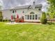 A spacious backyard features a covered deck and patio with outdoor furniture at 9001 Fenwick Dr, Indian Trail, NC 28079