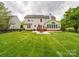A spacious backyard features a covered deck and patio with outdoor furniture at 9001 Fenwick Dr, Indian Trail, NC 28079
