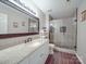 The remodeled bathroom has a glass shower, granite countertop, and wood-look tile at 9001 Fenwick Dr, Indian Trail, NC 28079