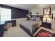 Bedroom with a modern bed frame, a desk, and dark soundproofing foam wall at 9001 Fenwick Dr, Indian Trail, NC 28079