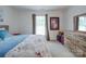 This neutral bedroom features a large window and matching wood furniture at 9001 Fenwick Dr, Indian Trail, NC 28079