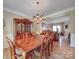 Dining room with hardwood floors, a chandelier, and direct access to the living room at 9001 Fenwick Dr, Indian Trail, NC 28079