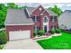 Attractive two-story brick home with an attached garage and landscaped front yard at 9001 Fenwick Dr, Indian Trail, NC 28079