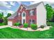 Charming brick home featuring lush green lawn and mature landscaping at 9001 Fenwick Dr, Indian Trail, NC 28079