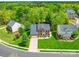 Charming brick two-story home with a manicured lawn and mature trees providing shade at 9001 Fenwick Dr, Indian Trail, NC 28079