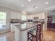 Open kitchen features granite countertops, a breakfast bar, and white cabinetry at 9001 Fenwick Dr, Indian Trail, NC 28079