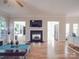 Open-concept living room featuring hardwood floors and a cozy fireplace at 9001 Fenwick Dr, Indian Trail, NC 28079