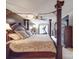 A main bedroom featuring a stylish four-poster bed and exercise equipment near a window at 9001 Fenwick Dr, Indian Trail, NC 28079