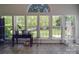 Window-lined sunroom with tile flooring, potted plants, and backyard views at 9001 Fenwick Dr, Indian Trail, NC 28079