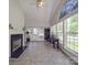 Bright sunroom with a fireplace, tiled floors, and lots of natural light from many windows at 9001 Fenwick Dr, Indian Trail, NC 28079