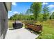 View of a back patio with a grill, flower boxes, and view of a large grassy backyard at 9077 Myrna Dr, Gastonia, NC 28056