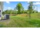 A vast, grassy backyard space is complemented by verdant foliage, offering plenty of room to enjoy the outdoors at 9077 Myrna Dr, Gastonia, NC 28056