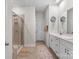 This bathroom features a double vanity, large mirror, tile floors, and a stand-up shower at 9077 Myrna Dr, Gastonia, NC 28056