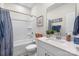 Bright bathroom featuring a tub, shower, single vanity, and blue accents at 9077 Myrna Dr, Gastonia, NC 28056