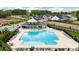 A large, inviting community pool is surrounded by lounge chairs, tables, and a covered seating area at 9077 Myrna Dr, Gastonia, NC 28056