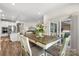 Inviting dining area with access to the rear patio via sliding glass doors and open to the modern kitchen at 9077 Myrna Dr, Gastonia, NC 28056