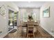 Cozy dining area featuring a rustic table and chairs, a sliding glass door and a view of the backyard at 9077 Myrna Dr, Gastonia, NC 28056