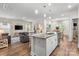 Open-concept kitchen and living room featuring granite countertops and an island with seating at 9077 Myrna Dr, Gastonia, NC 28056