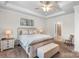 Comfortable main bedroom with neutral tones, a tray ceiling, a ceiling fan, and soft lighting at 9077 Myrna Dr, Gastonia, NC 28056