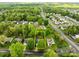 Overhead shot of the property emphasizing its location within a lush neighborhood, surrounded by mature trees and greenery at 909 Jordans Pond Ln, Charlotte, NC 28214