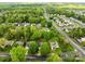 An aerial view of a neighborhood featuring mature trees and well-maintained lawns in a suburban setting at 909 Jordans Pond Ln, Charlotte, NC 28214